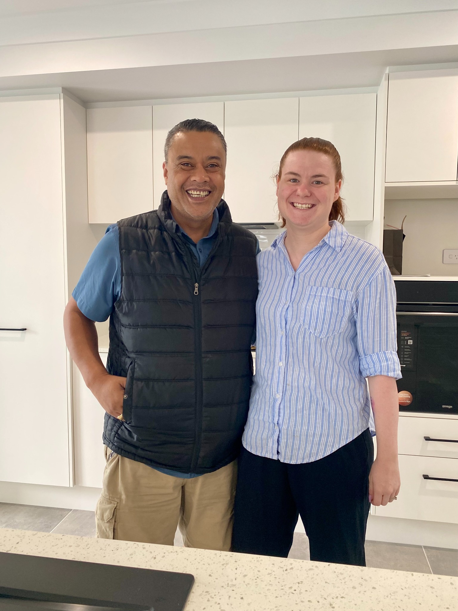 Pio and Annaleesha smiling in the kitchen of their new home