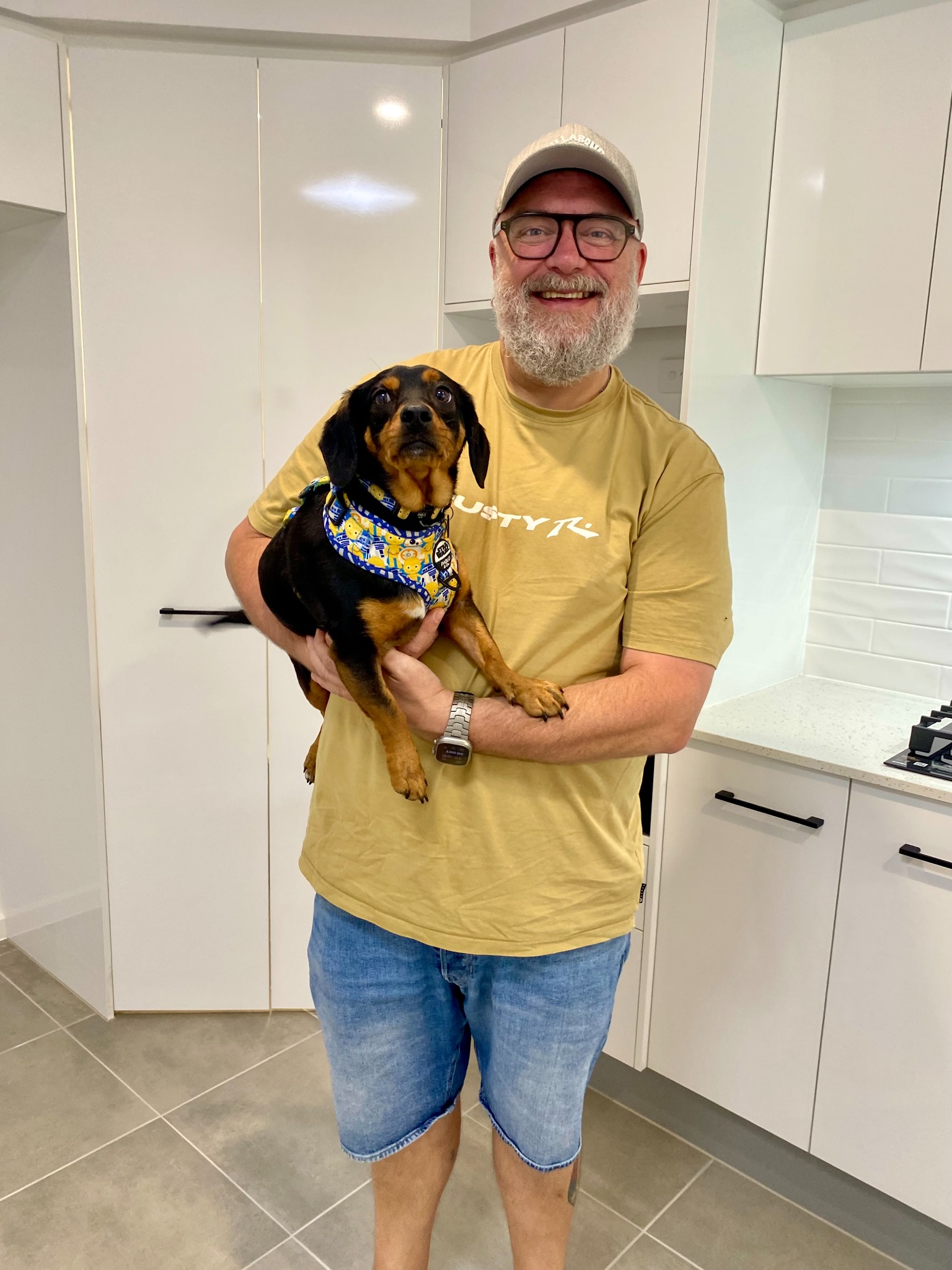 Scott holding Odo in the kitchen of their new home